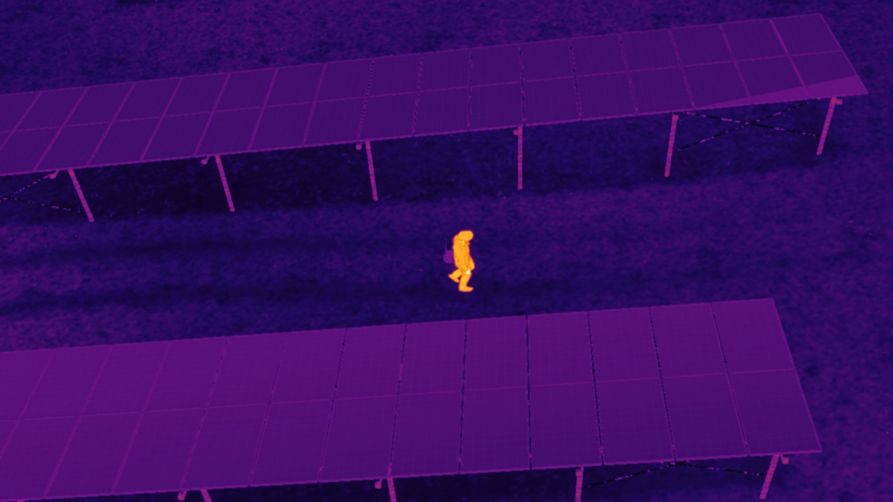 A person seen through the thermal camera at night